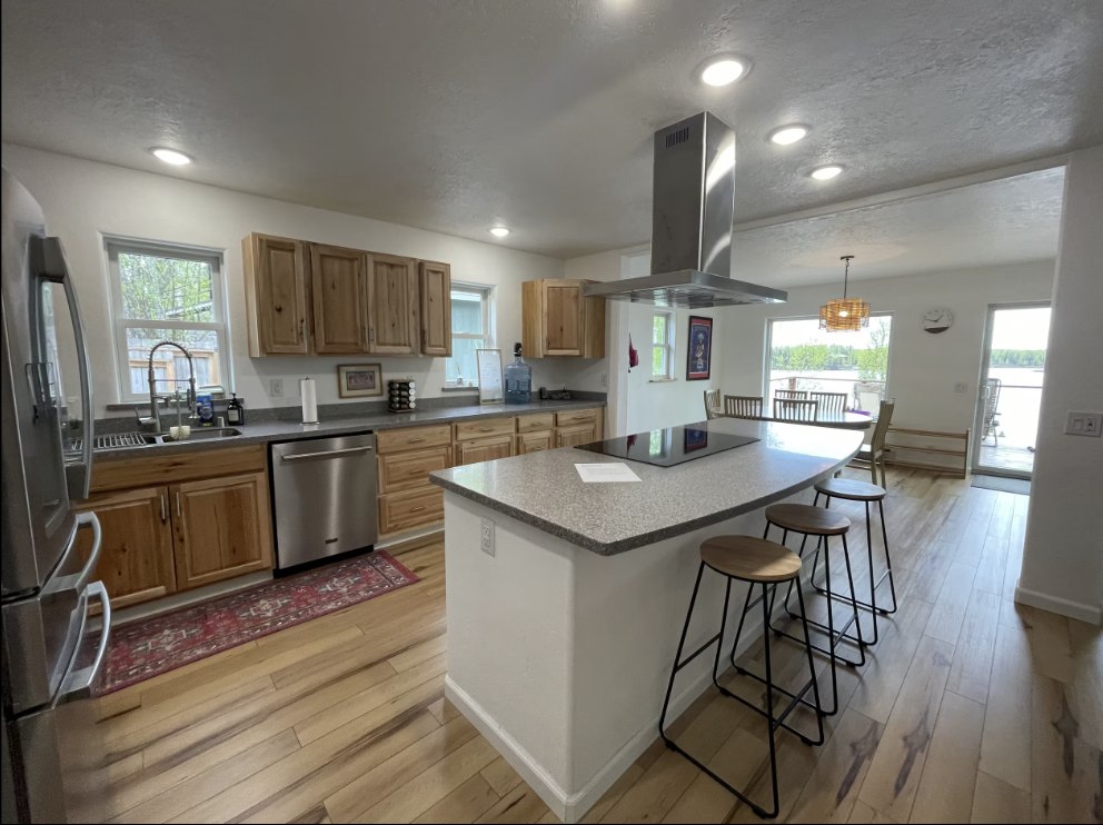 Full kitchen with island seating and lake-view dining space