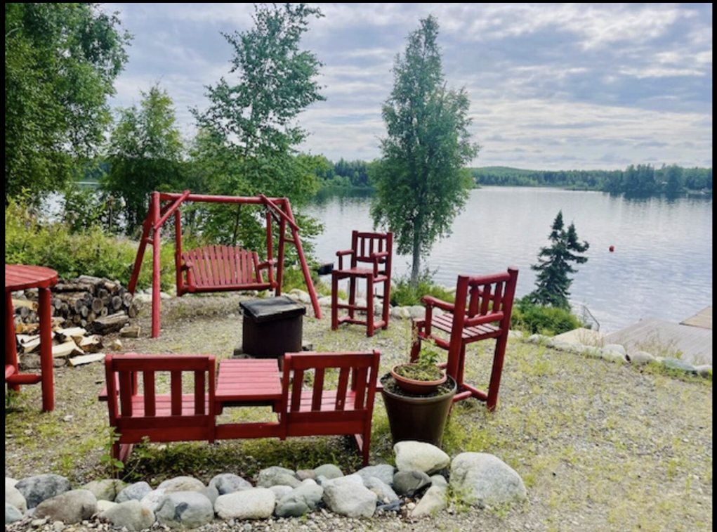 Red swing and chairs overlooking Nancy Lake