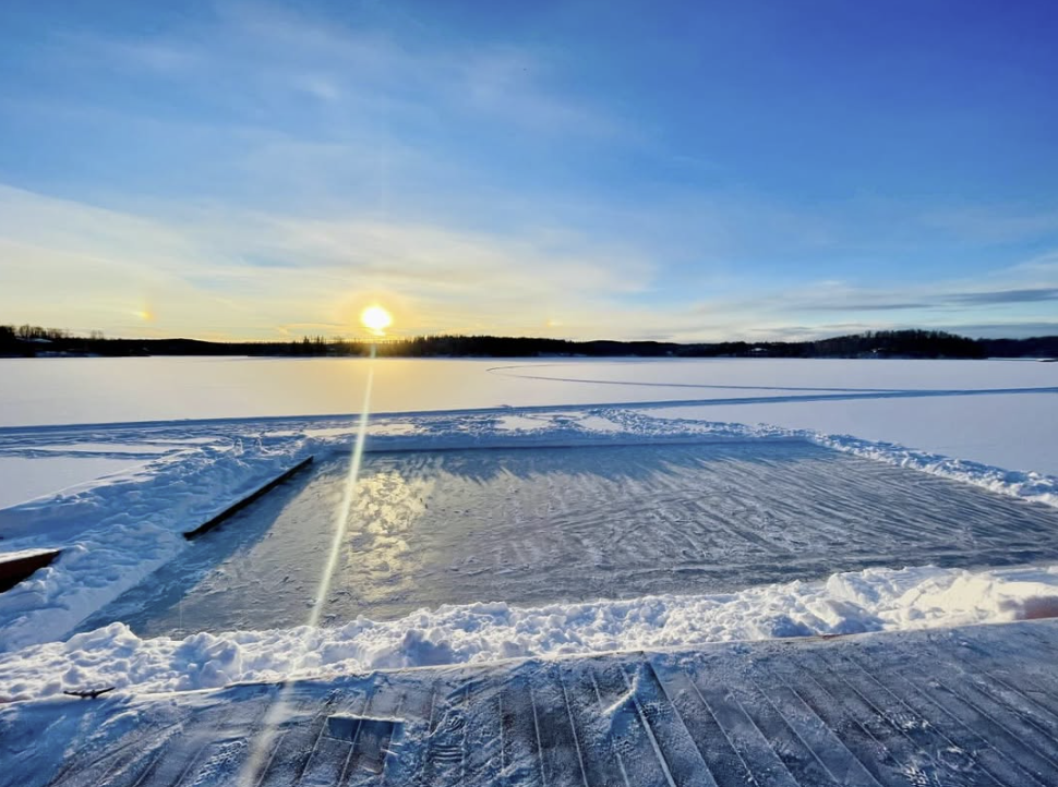 Sunset over the cleared ice-skating rink on frozen Nancy Lake